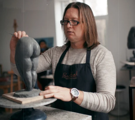 Veaceslav Jiglitski shaping a clay figure in his studio